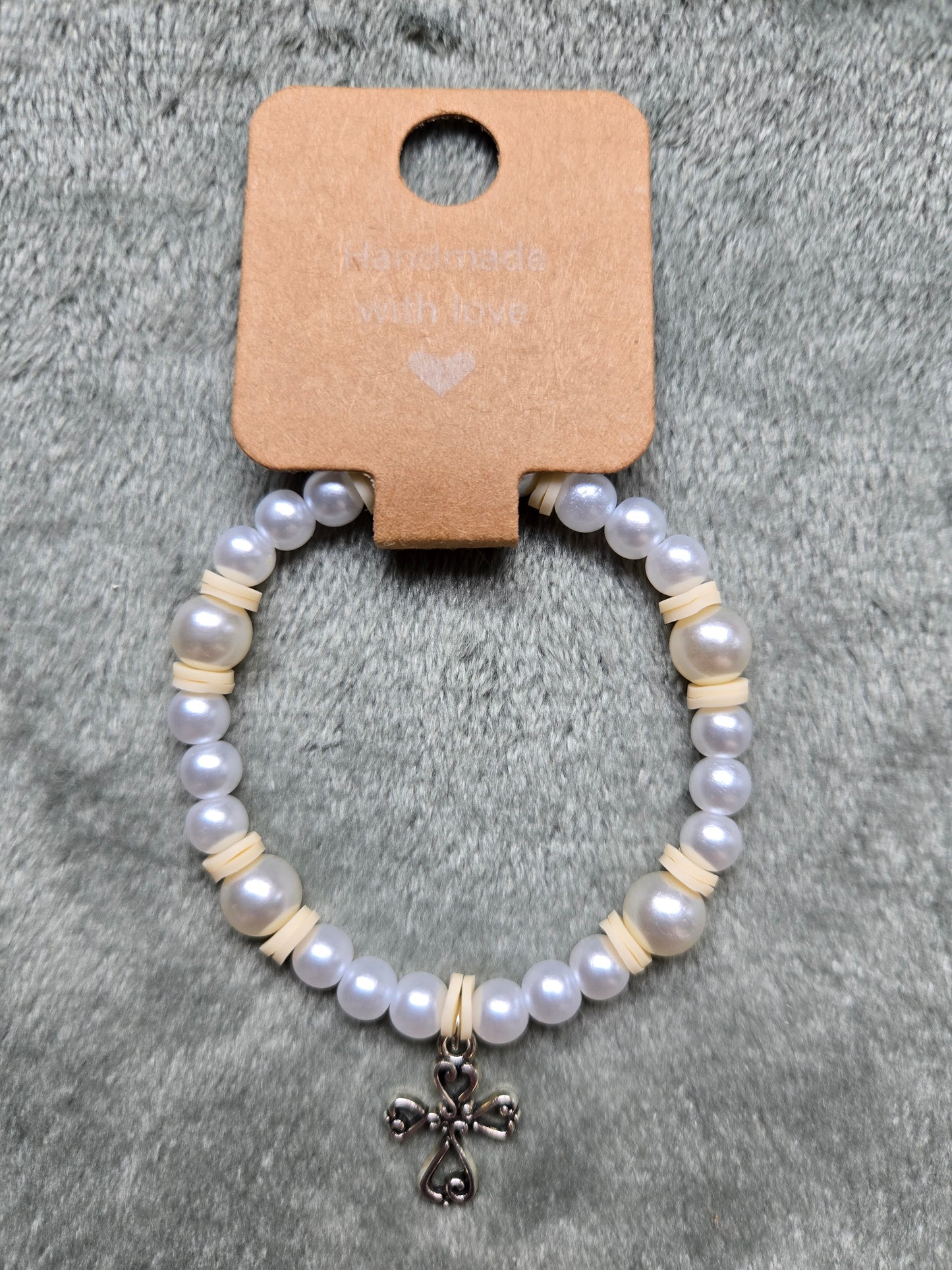 White and cream beaded bracelet with silver cross charm