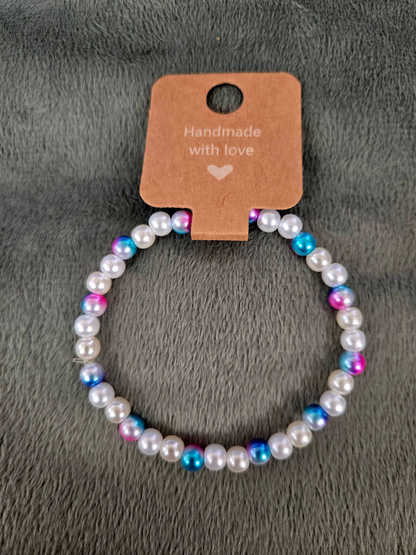 White, blue and pink beaded bracelet