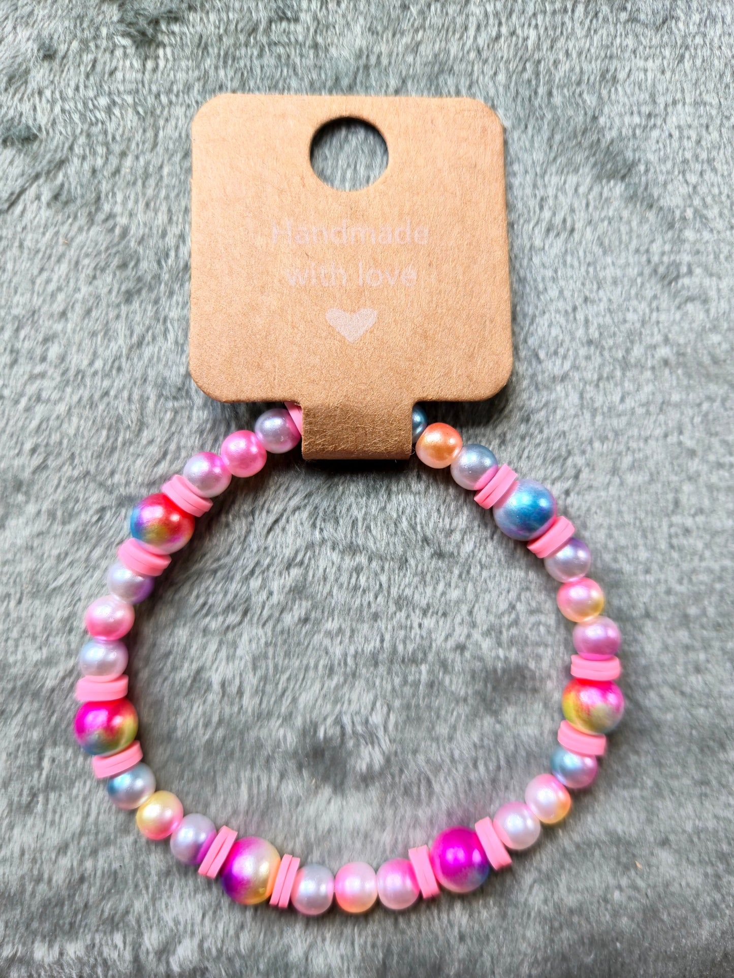 Multicolored beaded bracelet with pink clay beads