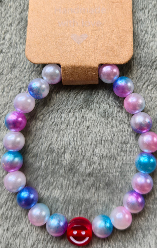 Pink and blue beaded bracelet with a smiley face bead