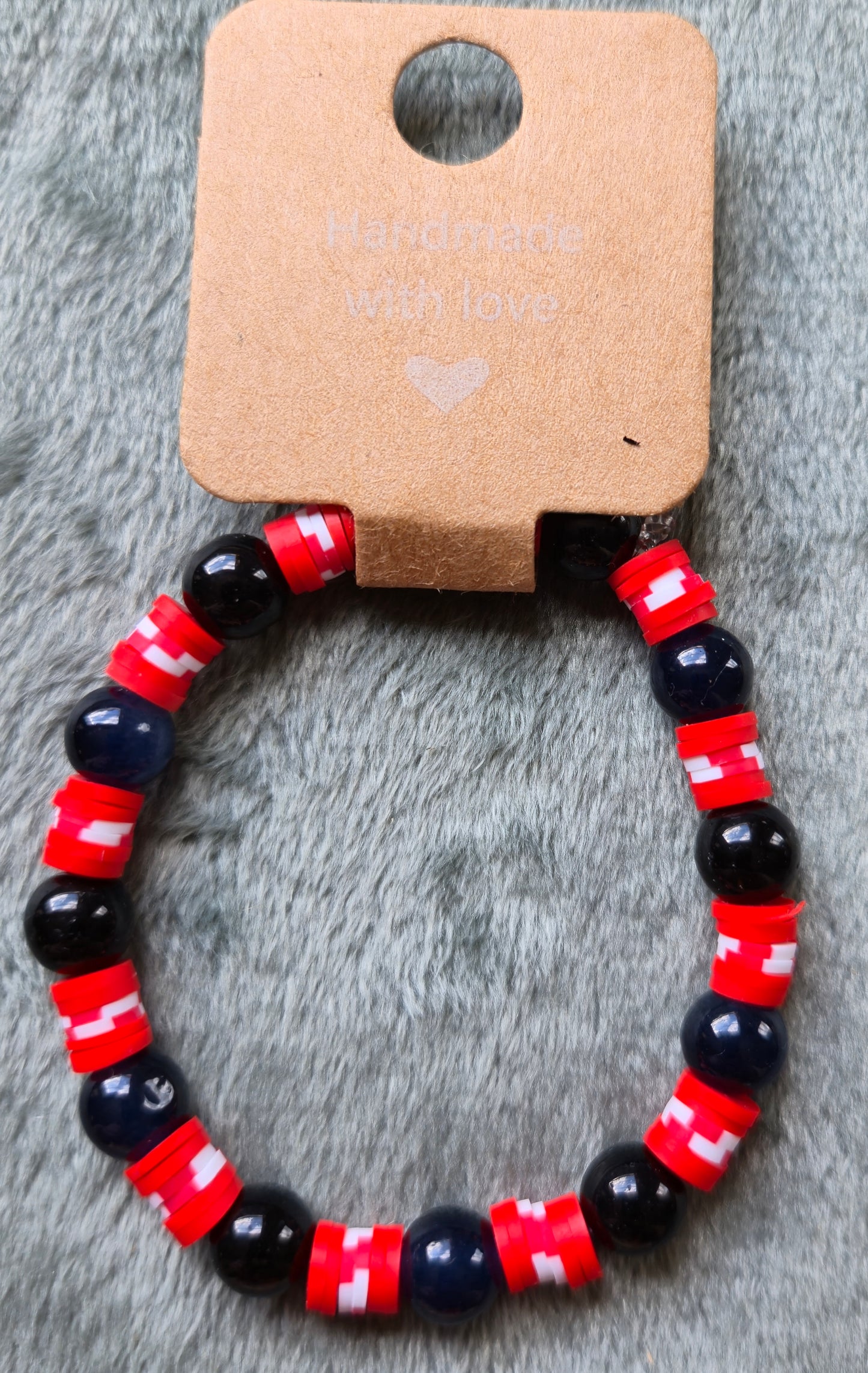 Black and red beaded bracelet with hints of white