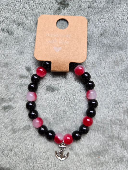Black and red beaded bracelet with silver anchor charm