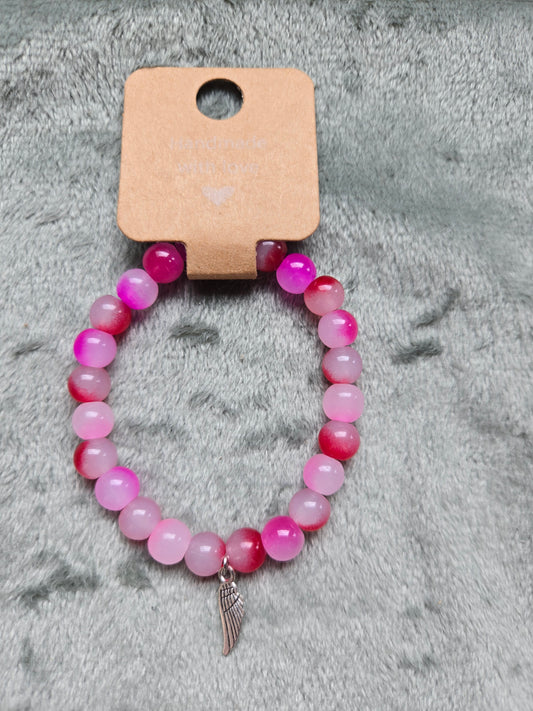 Pink beaded bracelet with silver wing charm
