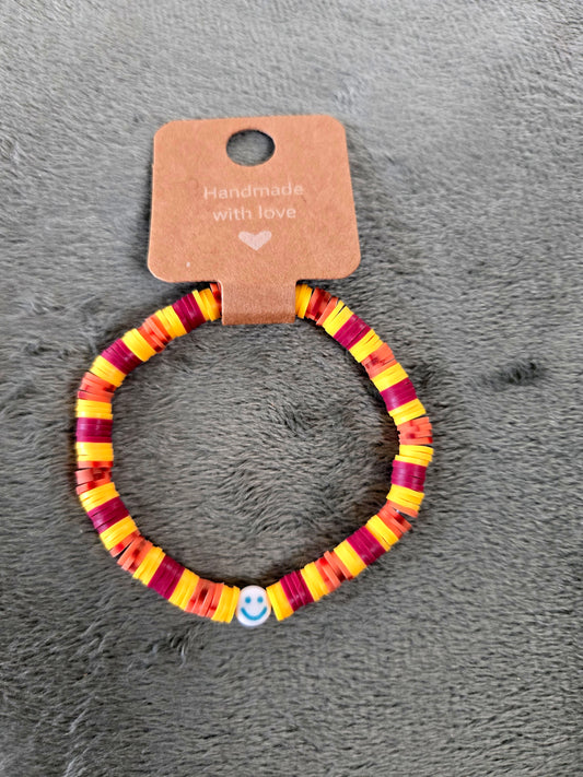 Yellow and burgundy clay beaded bracelet with smiley face